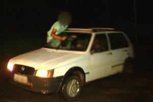 Passageiro é flagrado sentado na janela do carro para mover para-brisa, em Luziânia